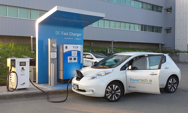 Car parked at EV charging station. 