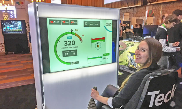 Amanda Truscott, CCO of Rithmik Solutions, tests a view for haul truck drivers at the Teck booth in the summit marketplace.
