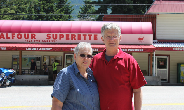 Senior couple stand in front of Balfour Superette store