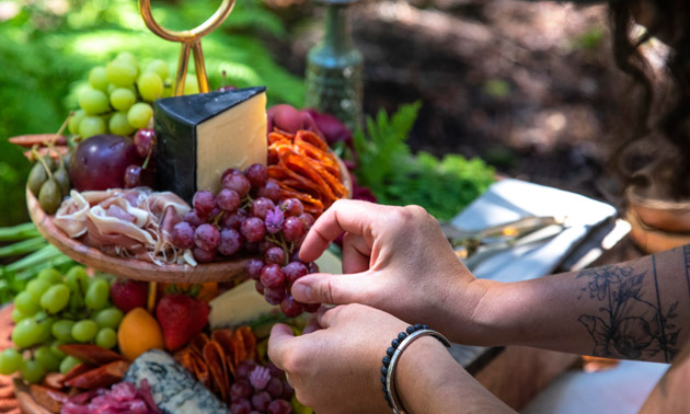 Charcuterie platter filled with meats, cheeses and fruit. 