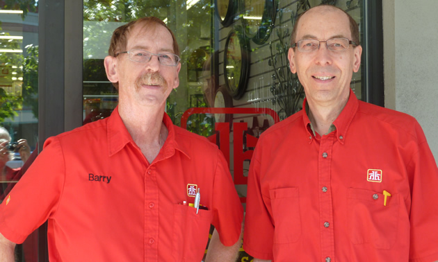 Two middle-aged men in red summer Home Hardware shirts