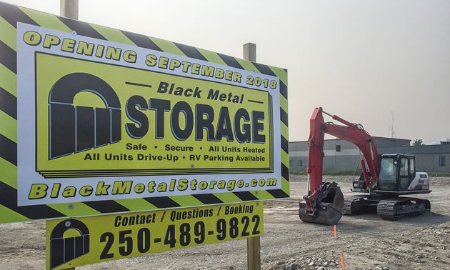 A sign advertising the future opening of Black Metal Storage. 