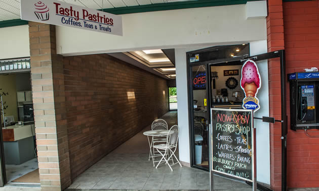 The entrance to Tasty Pastries features a blackboard showing all the daily specials.
