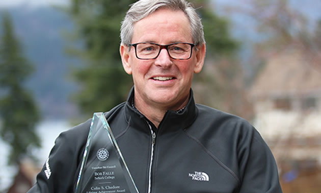 Picture of Bob Falle holding the Lifetime Achievement Award from the Canadian Ski Council. 
