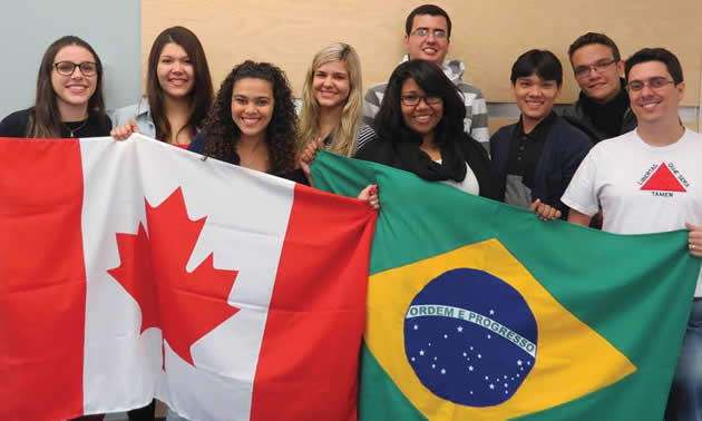 Group of students from the College of the Rockies holding the Canadian and Brazilian flags