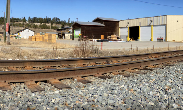 View of train tracks and industrial buildings. 