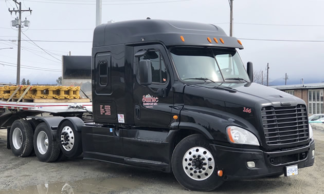 Sunrise Transport truck sitting outside. 