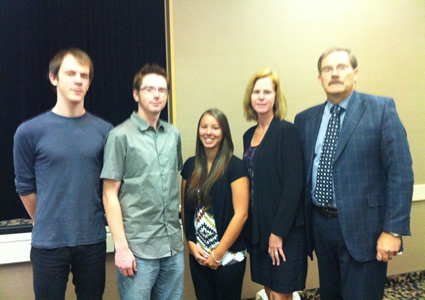 Photo of COTR scholarship winners Nicholas Johnson, Danielle Elliott and Daniel Marti shown with publisher Keith Powell.