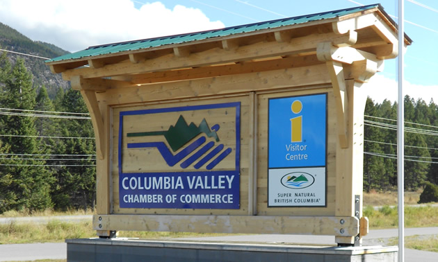 Timber structure displays a sign for the Columbia Valley Chamber of Commerce and Visitor Centre