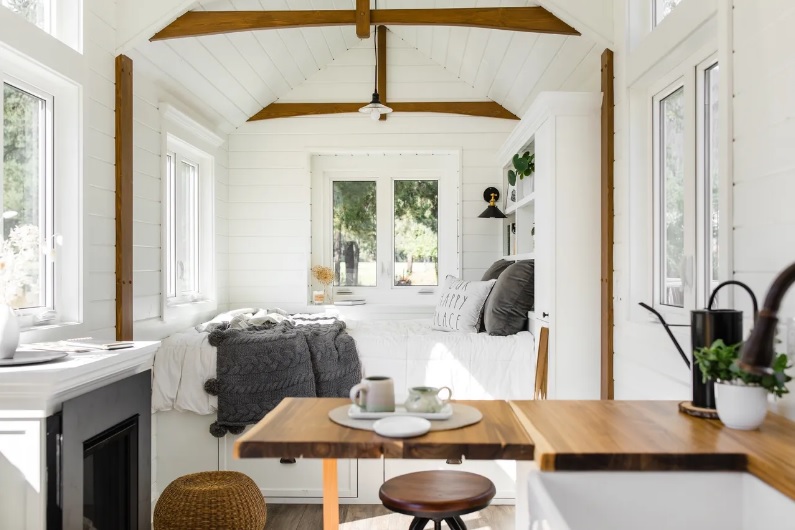 The interior of the 30' Sitka, showing wood beams, white walls and lots of natural light from large windows. 