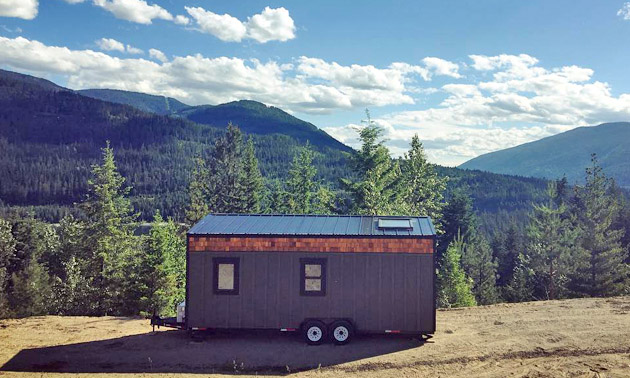 Tiny home with view of mountains in background. 