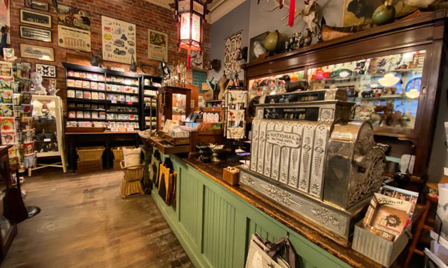 Interior of Cartolina store showing antique cash register and shelves. 