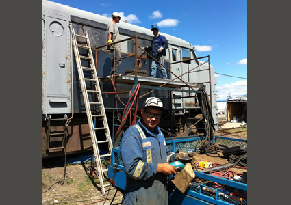 Fabrite Services employees and Sunrise Rotary member Carl Casey busy at work on the Alco restoration project.