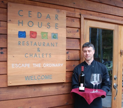 a man holding a tray of wineglasses.