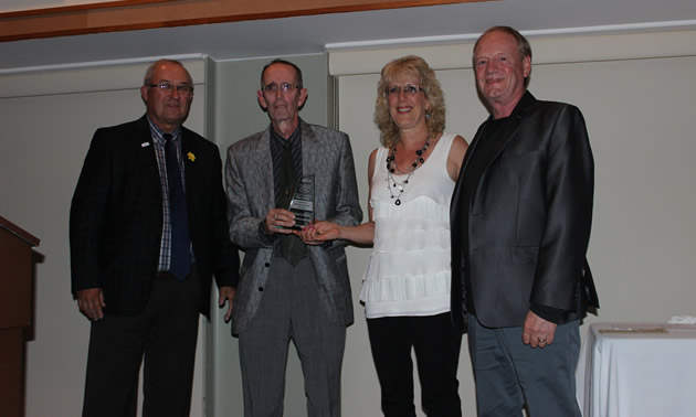 Castlegar mayor Lawrence Chernoff (left) congratulates the Oglow family on its Lifetime Achievement Award from the Castlegar & District Chamber of Commerce. 