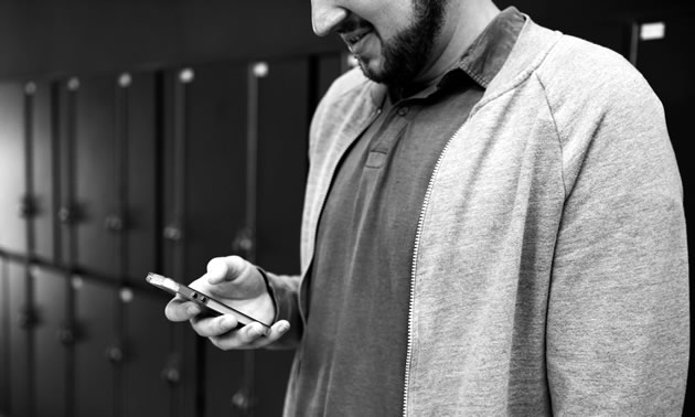 A man looking at his cellphone.