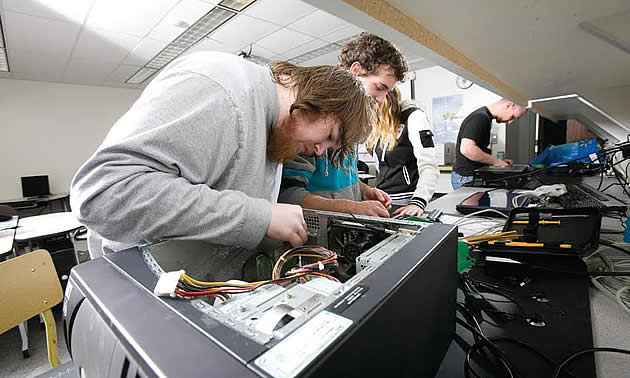 Student working to repair a computer
