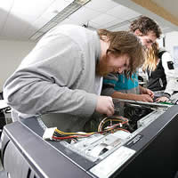 Student working to repair a computer
