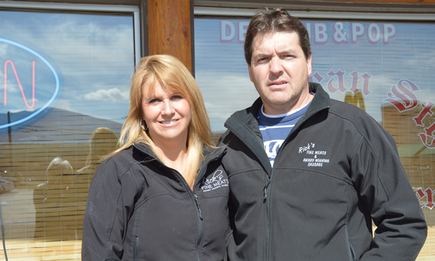 Couple stands outside a commercial building