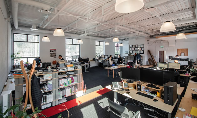 The interior of Cover Architecture with all sorts of tables.