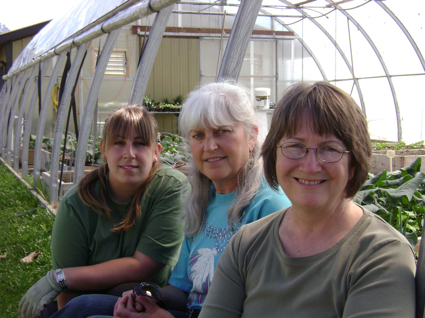 Photo of Kristy Pelletier, Anita Sawyer and Karen Powis in front of a greenhouse
