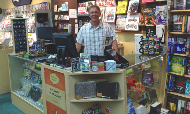 Brad Crockett stands behind his counter at Crockett Book Company in Trail, B.C.