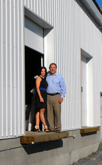 Joey and Christine Hoechsmann at the entrance of their new distribution centre located at the old Liquidation World location in Cranbrook, B.C.