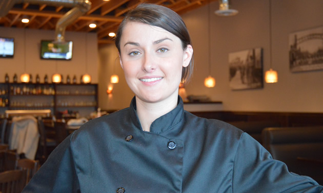 Young woman wearing a black chef jacket