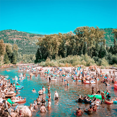 View of Salmo River full with beach goers. 