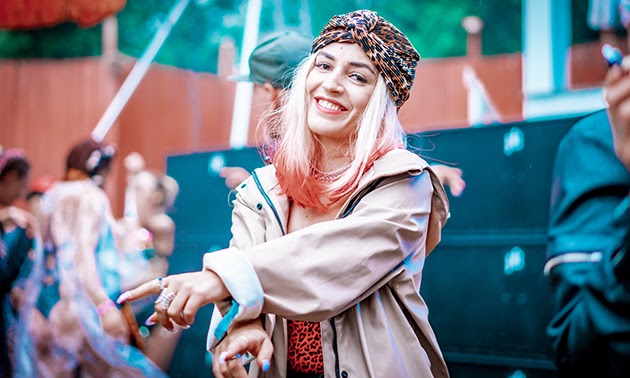 Female Shambhala festival goer, smiling. 