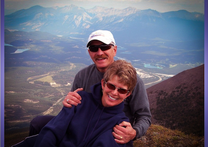 A couple hugging on a hill; scenic background 