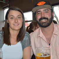 Dark-haired young woman with dark-haired and dark-bearded young man