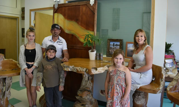 Jeremy and Sarah Smith and their three children in their store. 