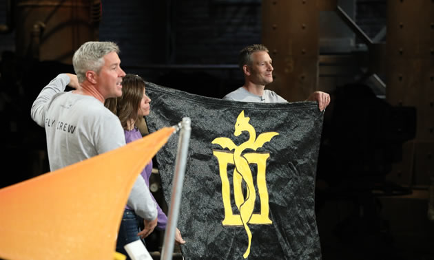 Brydon Roe, Anne Murphy and Graham Harper are holding a black shade with an image of a dragon on it on Dragons’ Den on October 17.
