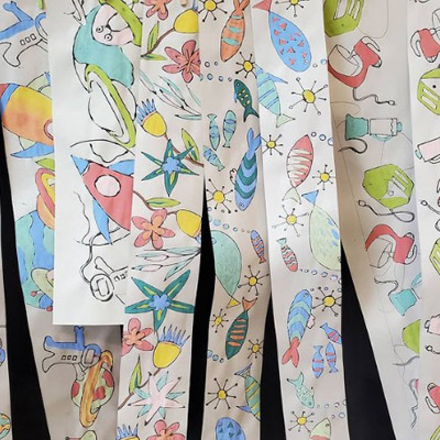 Colourful designs printed on long strips of paper. 