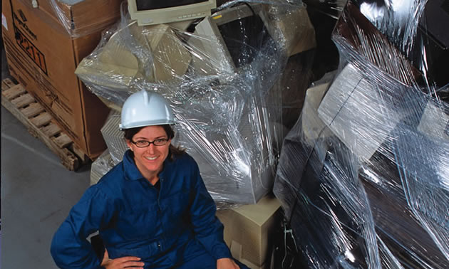 Christa Ford, a senior chemist at Teck Trail Operations, stands beside e-waste that will be recycled.