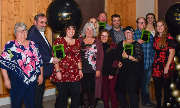 Group of award winners all smiling and holding awards. 