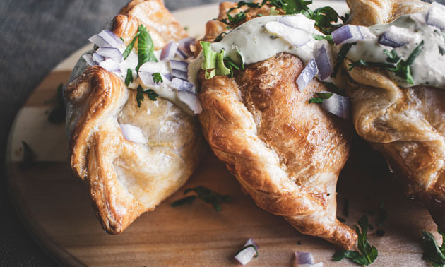 Close-up of empanadas, showing flaky pastry. 