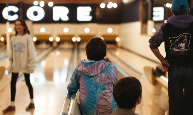 Kids at a bowling alley. 