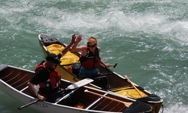 Two canoeists high-five
