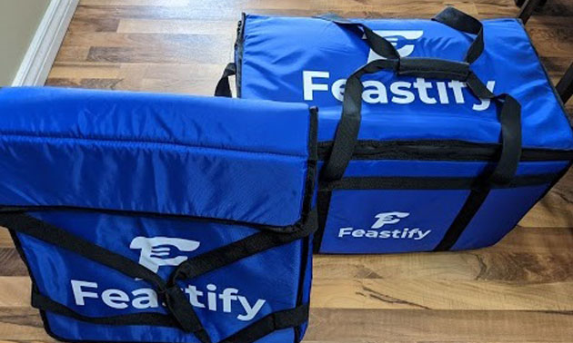 Blue Feastify branded delivery bags.