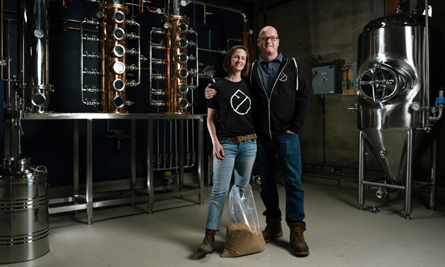 Owners of Fernie Distillers standing in their distillery room. 