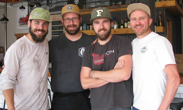 Four smiling, bearded young men: Ian McCann, Doug Wagner, Jesse Roberts and Fred Williams, are the team that oversees operations at Fire Hall Kitchen & Tap