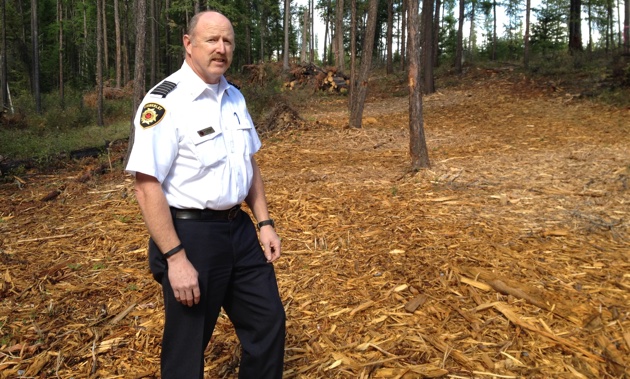 Kimberley Fire Chief Al Collinson is standing on tree chips from a fuel reduction project at Duck Pond.