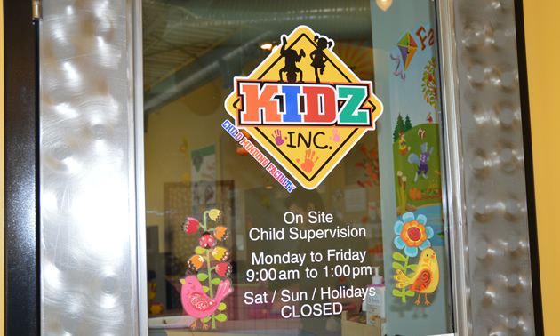 Glass door bears a sign saying Kidz Inc. Childminding Facility
