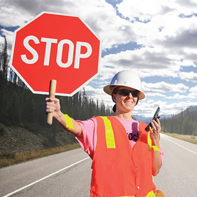 Flagger holding up stop sign. 