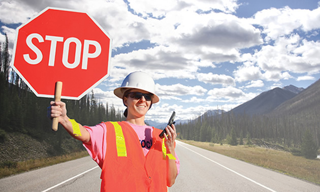 Flagger holding up stop sign. 