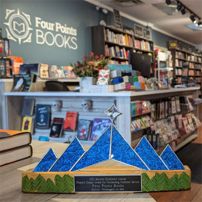 Interior photo of Four Points Bookstore with award in foreground. 