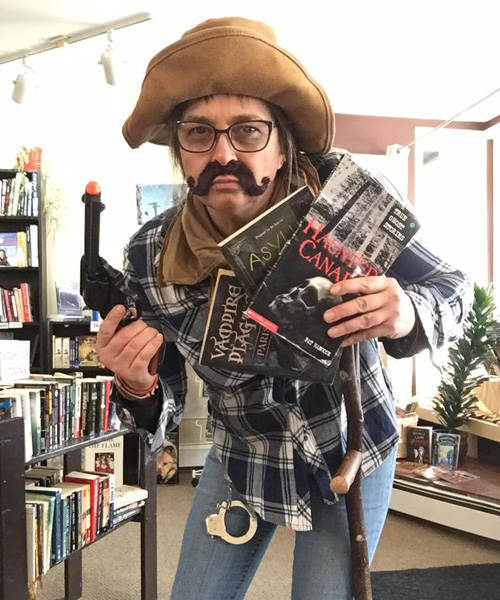 Michelle Fairbanks dressed as 'Prospector Sam', wearing fake moustache and old-time hat. 