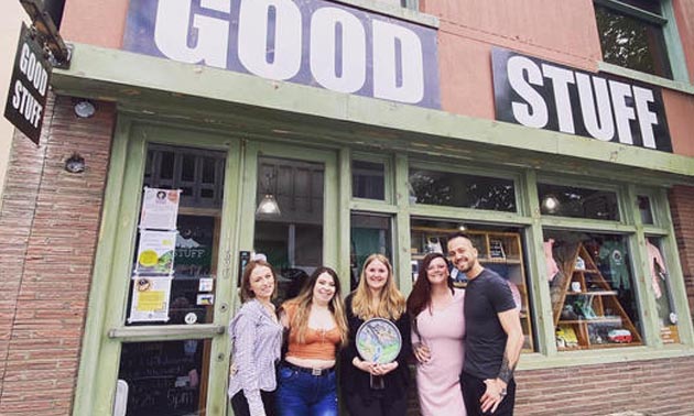 The staff and owners of popular downtown gift shop, Good Stuff, standing in front of store. 